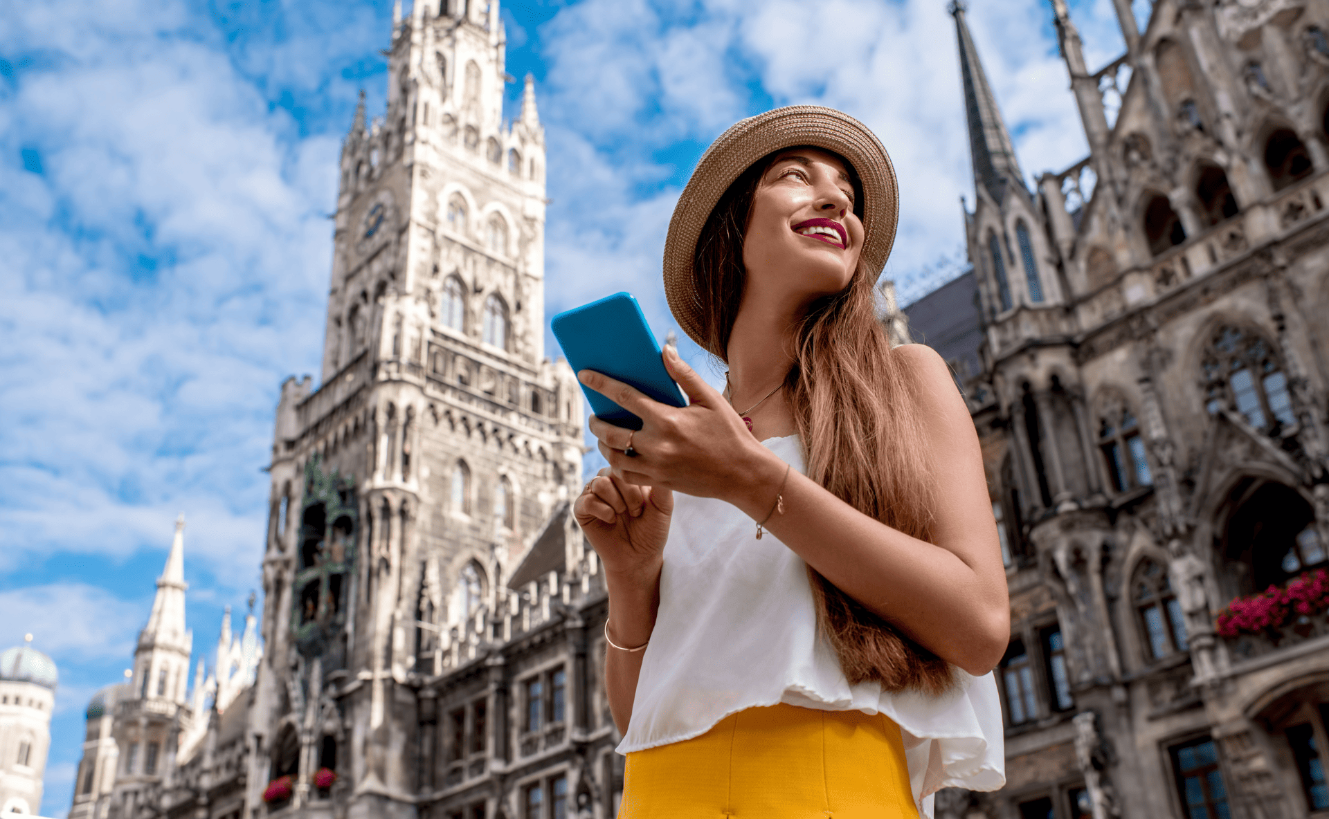 A female traveller in a city smiling with a smartphone - megatrends tourism 2026