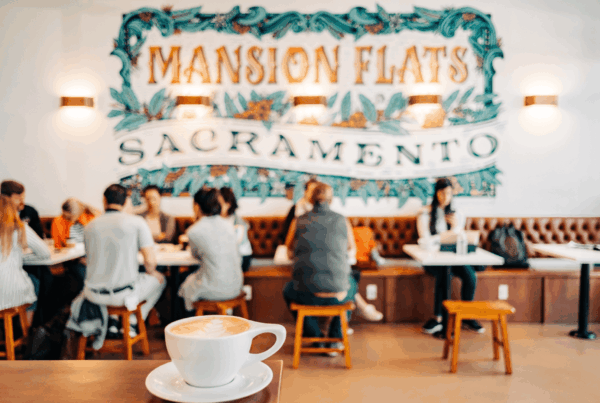 a cafe in sacramento with people seated around a table and a coffee cup in a corner