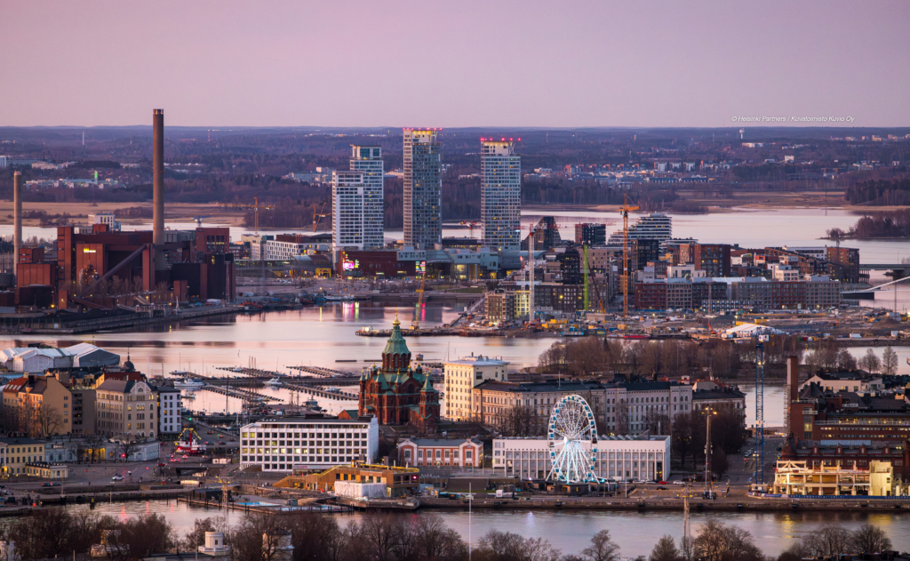 a panoramic view of Helsinki bathed in the warm golden light of sunset