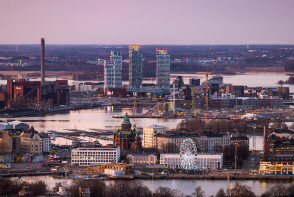 a panoramic view of Helsinki bathed in the warm golden light of sunset